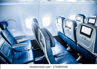 Interior of an empty airplane. View from the back of the plane. Nobody on the plane. Abstract air travel photo.
