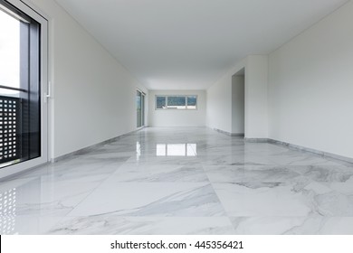 Interior of empty apartment, wide room with marble floor