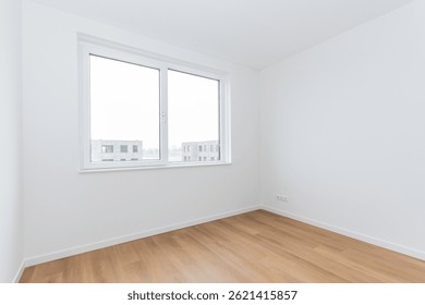 interior empty basic bedroom in modern new build residential smart house. Glass window is neighboring building over the road. Plain white walls and wood effect vinyl flooring make blank canvas