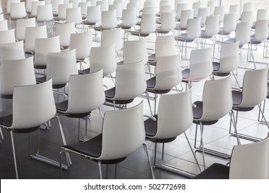 Interior Of Empty Contemporary Conference Hall With White Chairs.