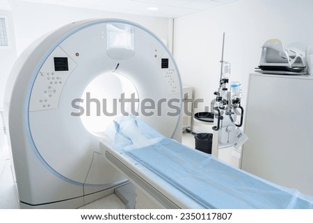 Interior of empty CT scan room in modern medical center is ready for procedure . High quality photo
