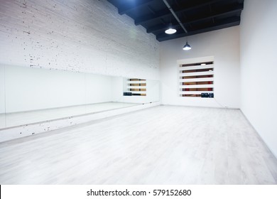 Interior Of An Empty Dance And Fitness Studio With Loft Design And Big Mirrors.