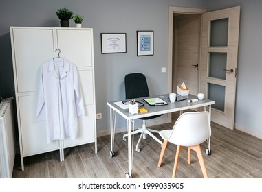 Interior of empty doctor's office with table and cupboard
