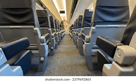 Interior of an empty first class cabin in a modern European train car.