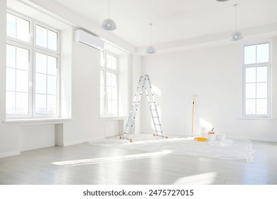 Interior of an empty house or office undergoing renovation or construction. The home room is in the repair stage, with a focus on improvement and creating a new, refreshed apartment space.
