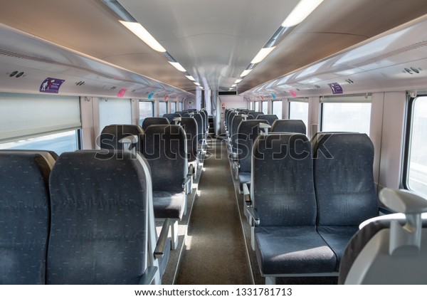 Interior of empty modern SNCB first class\
passenger wagon.\
Landscape.