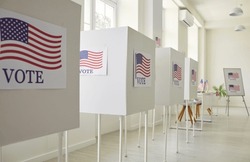 Interior Of An Empty Polling Place In The US. Row Of Empty White Voting Booths With American Flags At The Ballot Station. Elections In The USA, Democracy Concept 