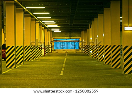 Interior of empty underground parking garage at night