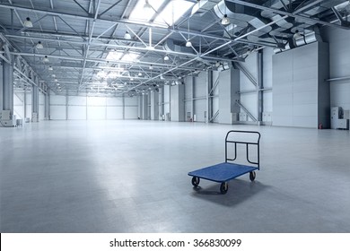Interior of empty warehouse with a cart