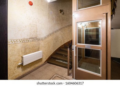 The interior of the entrance in a modern residential complex. Staircase. Elevator with glass door. - Shutterstock ID 1604606317