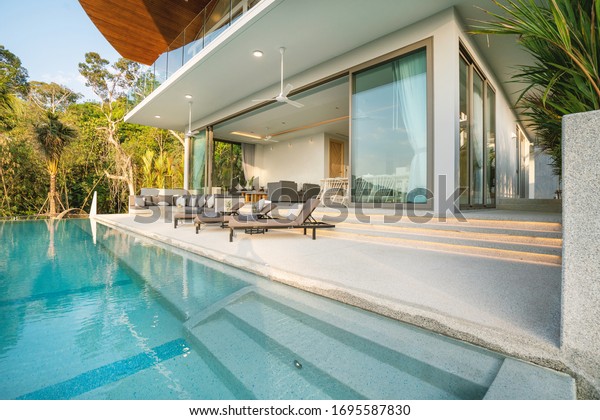 Interior and exterior design of
luxury pool villa, house and home feature terrace and sun
bed