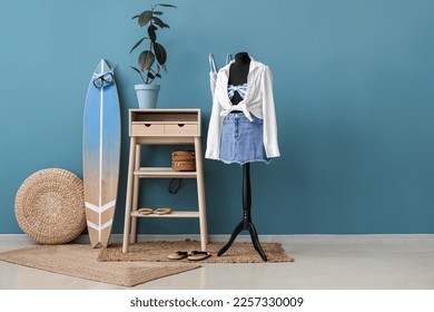 Interior of fashion designer's studio with mannequin, clothes and surfboard - Powered by Shutterstock