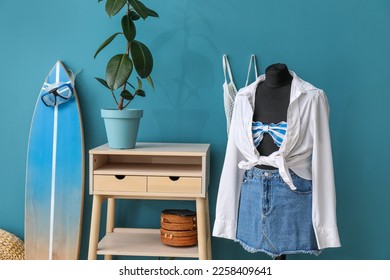 Interior of fashion designer's studio with mannequin, clothes and surfboard - Powered by Shutterstock