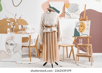 Interior of fashion designer's studio with mannequin, clothes and workplace - Powered by Shutterstock