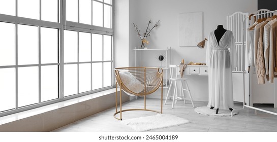 Interior of fashion designer's studio with mannequin, workplace and clothes - Powered by Shutterstock