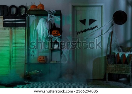 Interior of festive hallway with Halloween decorations at night