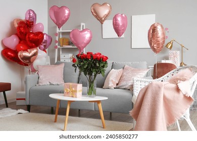 Interior of festive living room with grey sofa, heart-shaped balloons and bouquet of roses on coffee table. Valentine's Day celebration - Powered by Shutterstock
