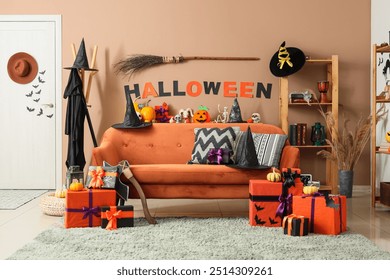 Interior of festive living room with sofa, Halloween decorations and gift boxes - Powered by Shutterstock