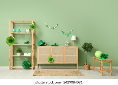 Interior of festive living room with wooden cabinet and decorations for St. Patrick's Day celebration - Powered by Shutterstock