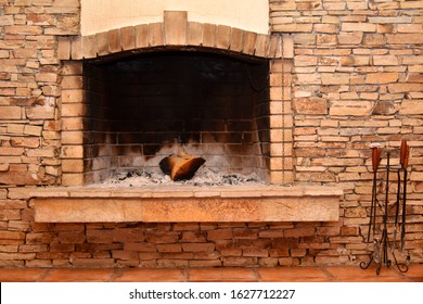 Interior Fire Place Built It Up Of Stone Bricks And Fire Tools Next To The Fire Place