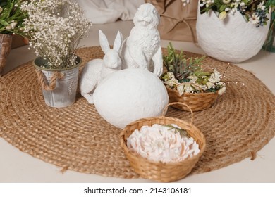 Interior Floral Easter Composition. Figurines Of Easter Bunnies And A Large Eggshell. The Concept Of Home Decoration For The Happy Easter Holiday