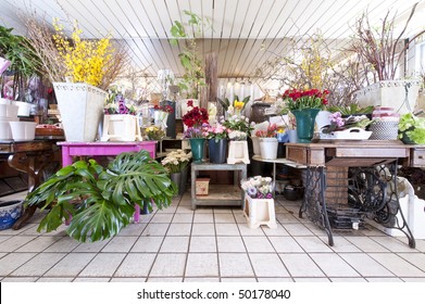 Interior Of A Flower Shop With Lots Of Different Country Styled Objects And Flowers