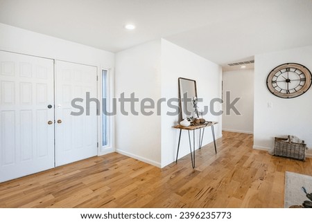 Interior foyer entry front door with hat rack coat hooks decor wood and tile flooring open door vaulted ceiling exposed brick wall welcome to a warm and comfortable family home