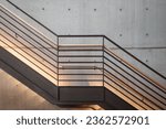 Interior front elevation view at the black steel staircase and background of modern loft concrete wall.