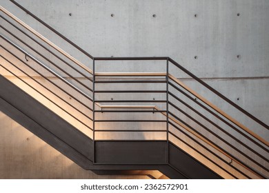 Interior front elevation view at the black steel staircase and background of modern loft concrete wall.