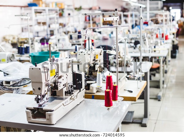Interior of garment factory shop. Closes making\
atelier with several sewing machines. Tailoring industry, fashion\
designer workshop, industry\
concept