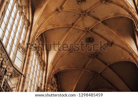 Interior of Gothic Cathedral, cornices and capitals, complex columnar column, ribs Lancet vault form unusual ceiling, huge Windows with roses