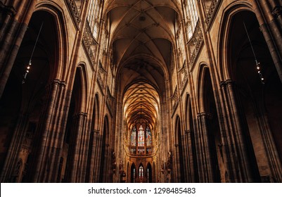Interior of Gothic Cathedral inside. Carved pulpit, stained-glass Windows through which light rays penetrate building Prague, Czech Republic - Powered by Shutterstock