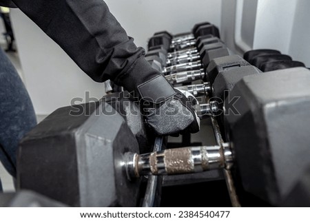 Interior of gym with equipment of large metal dumbbells. a close-up photo of a dumbbell