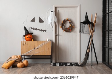 Interior of hall decorated for Halloween with door and commode