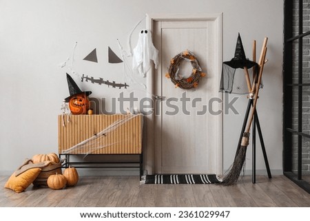 Interior of hall decorated for Halloween with door and commode