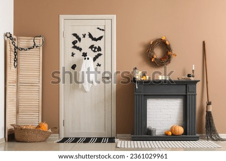 Interior of hall decorated for Halloween with door and mantelpiece