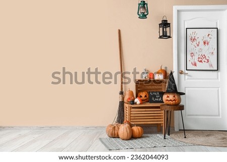 Interior of hall decorated for Halloween with door and pumpkins