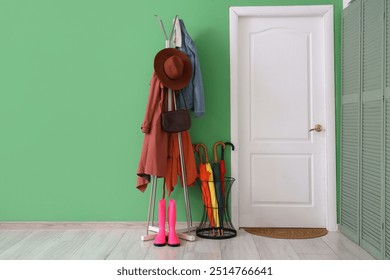 Interior of hallway with door, umbrellas and coat rack - Powered by Shutterstock