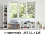 Interior of hallway with soft bench, shoes and plants