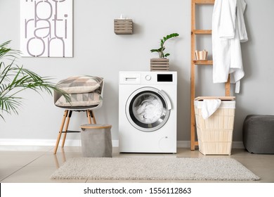 Interior of home laundry room with modern washing machine - Shutterstock ID 1556112863