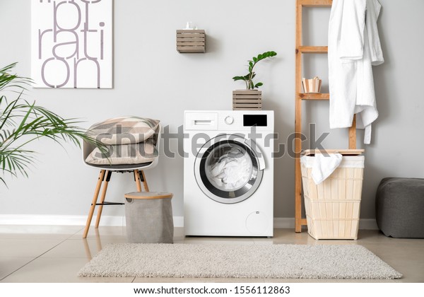 Interior\
of home laundry room with modern washing\
machine