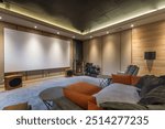 The interior of a home theater with modern equipment. Soft flooring, sofas and armchairs 
for comfortable viewing.