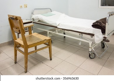 Interior Of Hospital Room With Bed And Old Chair