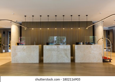 Interior Of A Hotel Lobby With Reception Desks With Transparent Covid Plexiglass Lexan Clear Sneeze Guards