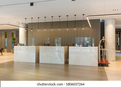 Interior Of A Hotel Lobby With Reception Desks With Transparent Covid Plexiglass Lexan Clear Sneeze Guards