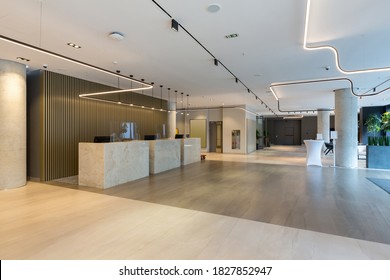 Interior Of A Hotel Lobby With Reception Desks With Transparent Covid Guards