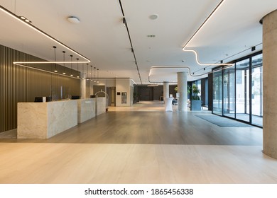 Interior of a hotel lobby with reception desks with transparent coronavirus guards - Shutterstock ID 1865456338