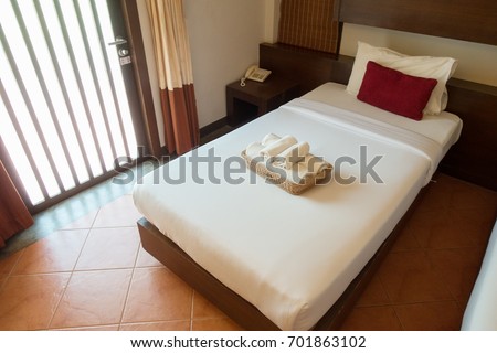The interior of a hotel room and single bed.