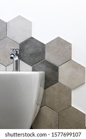Interior of a house, private bathroom. hexagonal tiles with natural colors on gray brown in a bathroom. interior furnishings and supplies, majolica mounted on the wall near a bidet.
					Interior design