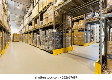 Interior Of A Huge Spacious Warehouse With Carton Boxes